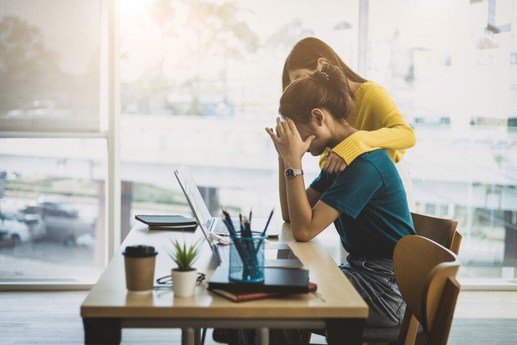 Supportive manager discussing workplace mental health and wellbeing with an employee